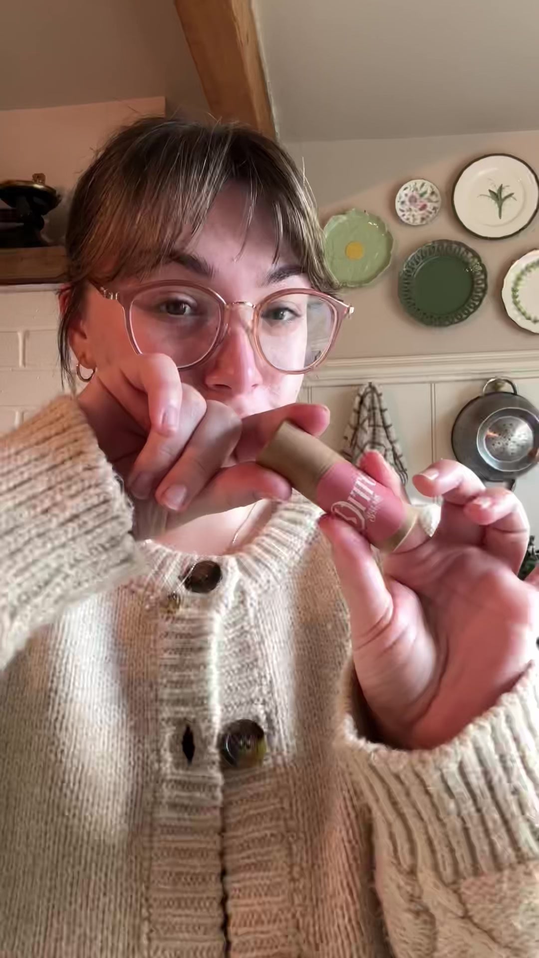 Emma is showing how to apply Ditto Balms solid perfume to pulse points